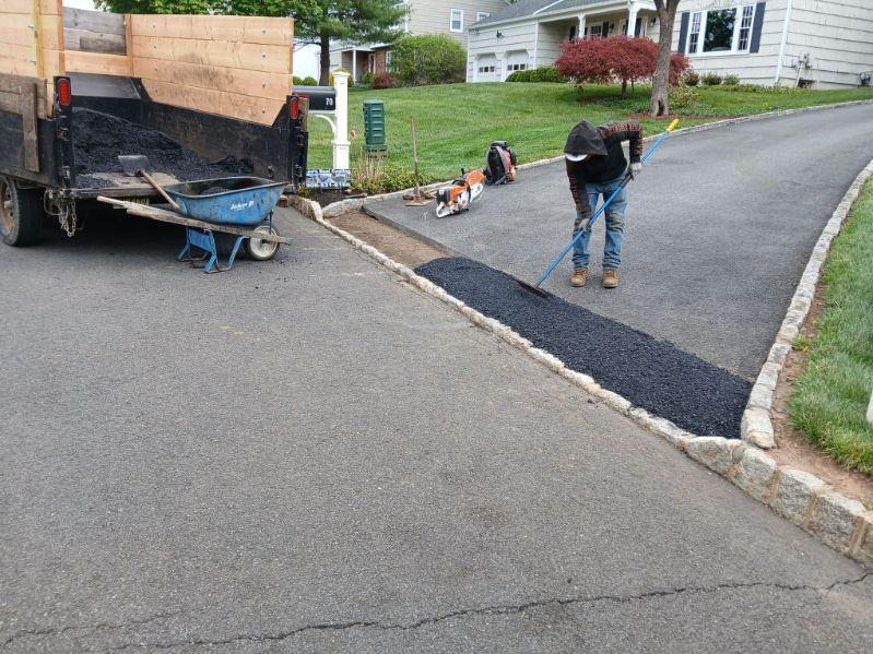 Driveway seal coating crew at work